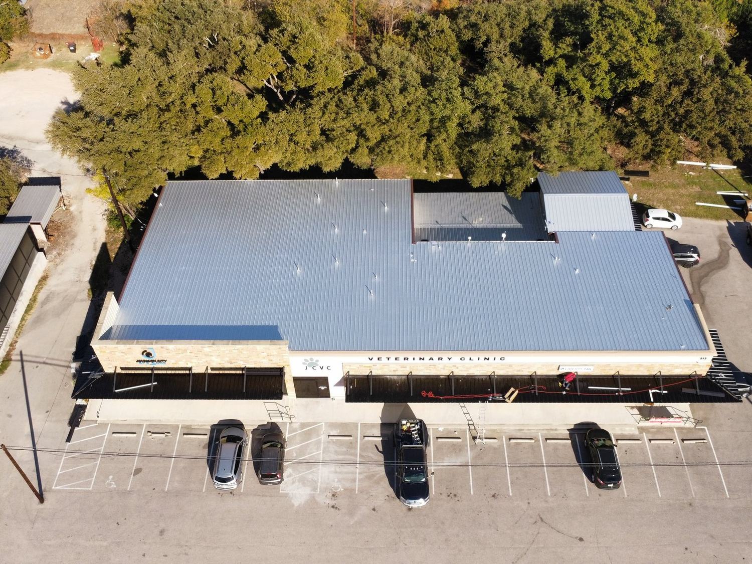 Aerial view of a completed commercial metal roof on a veterinary clinic