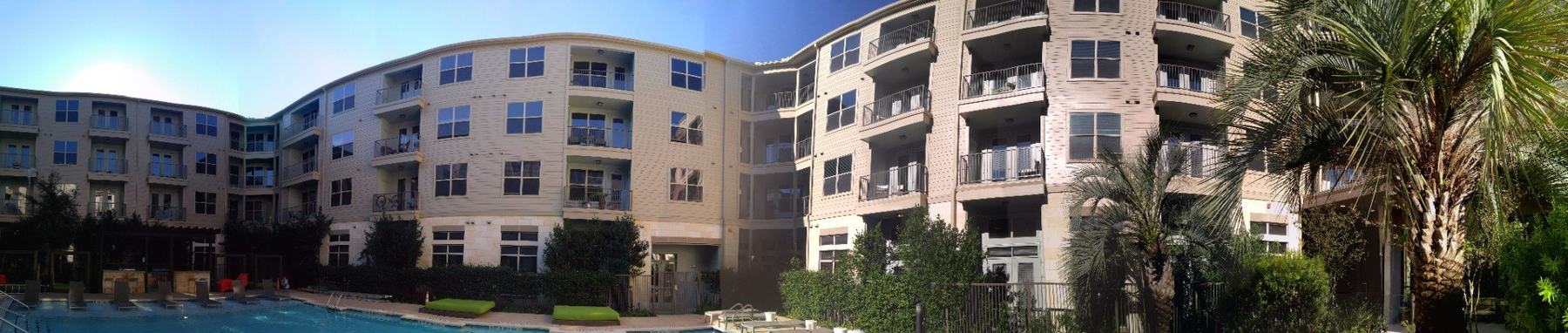 Large multifamily residential apartment property surrounding a pool courtyard