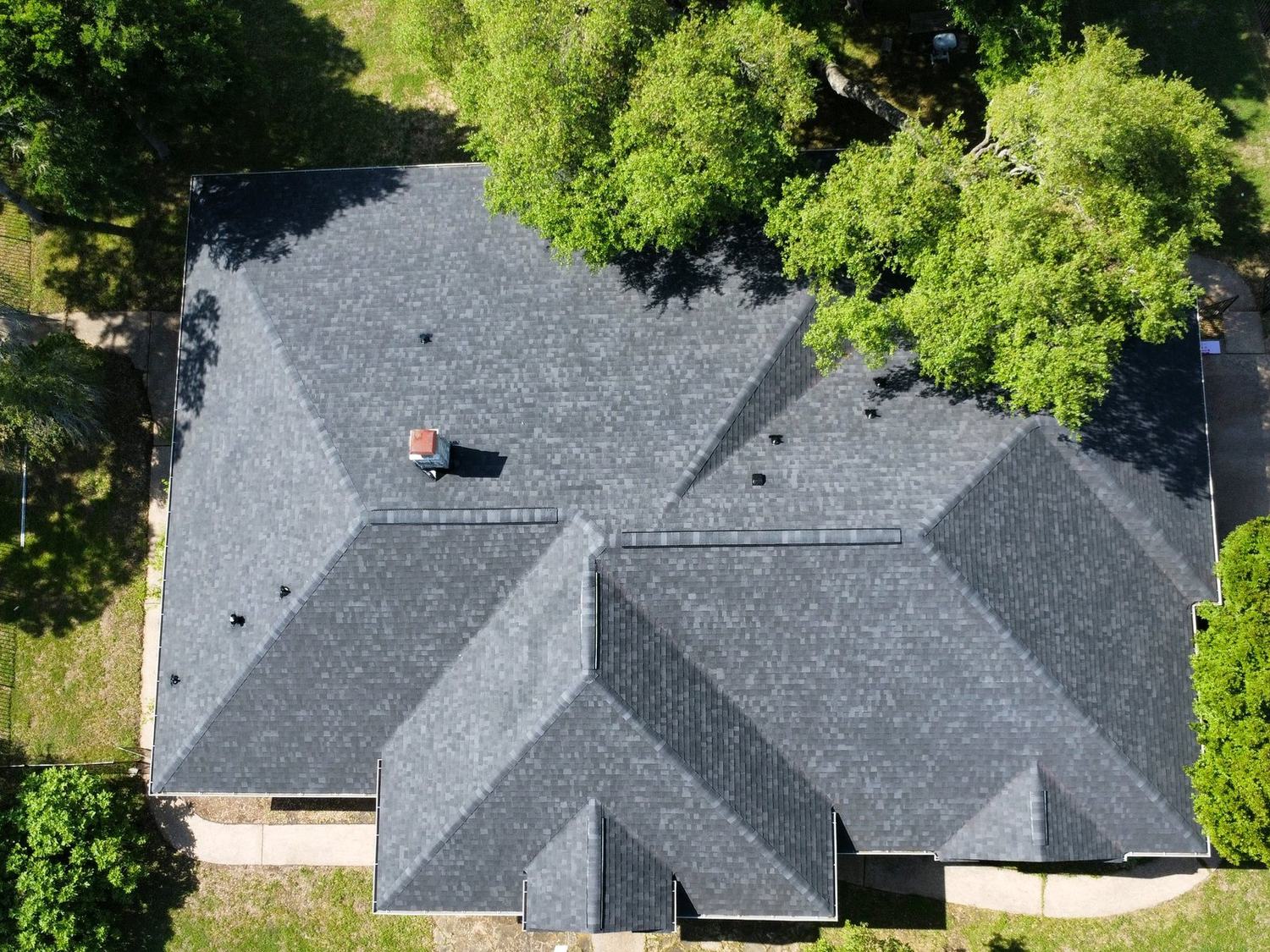 Overhead view of a completed gray architectural shingle roof