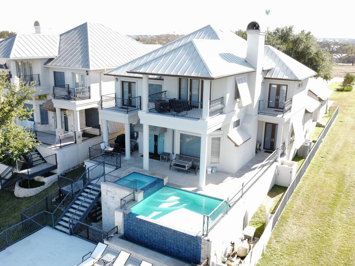 Large home with a completed light-colored standing-seam metal roof